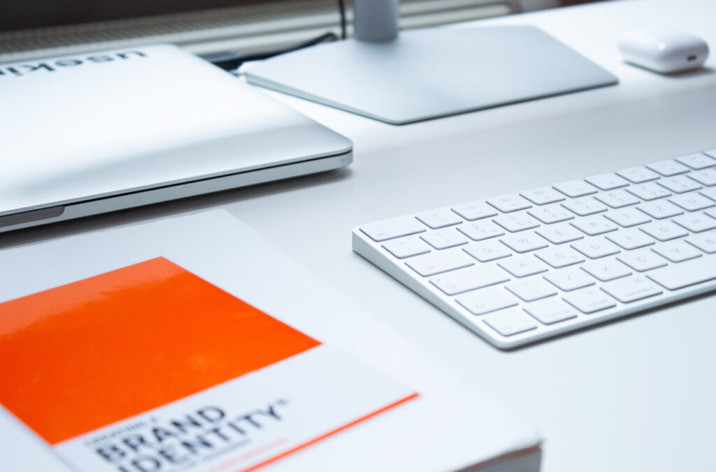 Laptop - Keyboard and Book - Silver and Orange Image